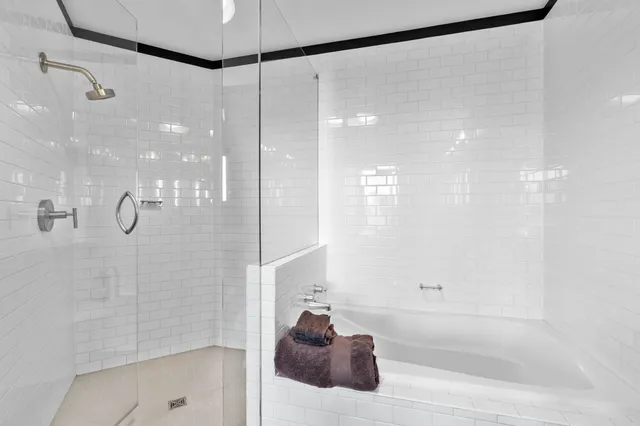 a view of a hallway with wooden floor and a living room