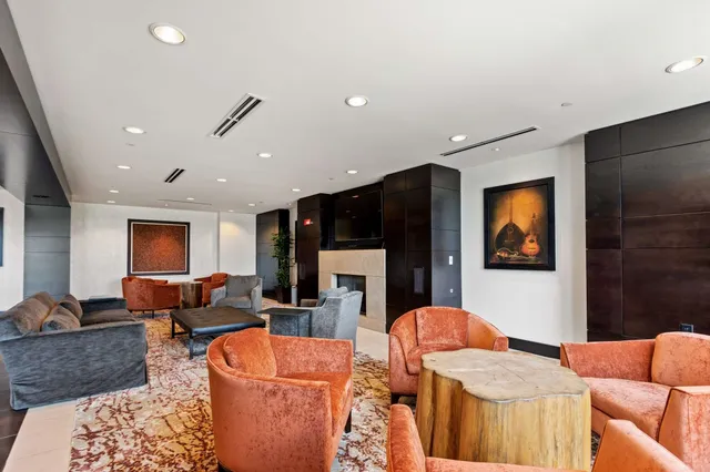 a kitchen with stainless steel appliances kitchen island granite countertop a table and chairs in it
