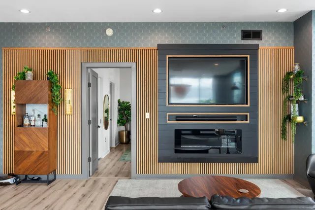 a living room with a fireplace and a flat screen tv