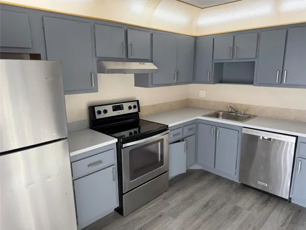 a kitchen with a stove and a refrigerator