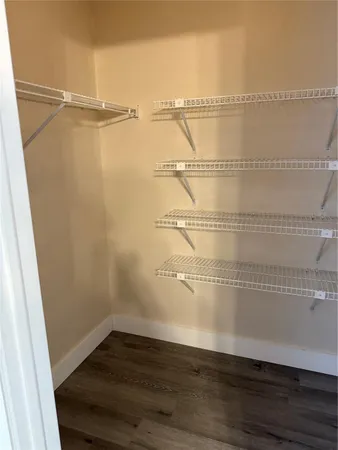 a view of a room with wooden floor and cabinet
