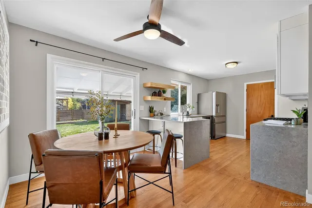 a dining room with furniture window and wooden floor