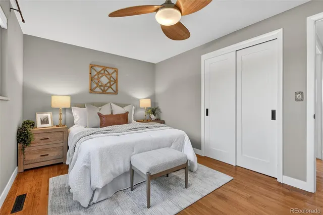 a bedroom with a bed and wooden floor