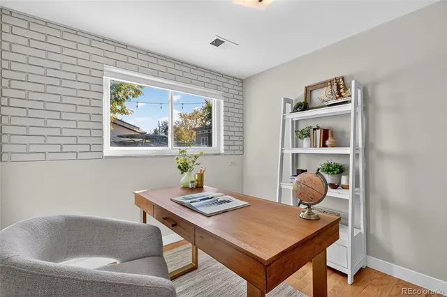 a view of a workspace with furniture and window