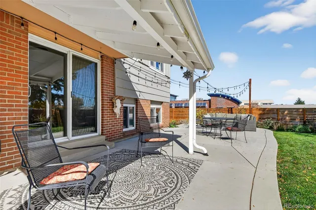 a building outdoor space with patio furniture and potted plants