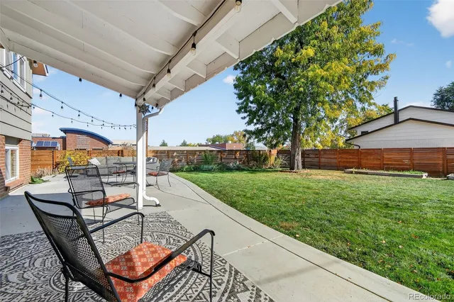 a view of a backyard with sitting area