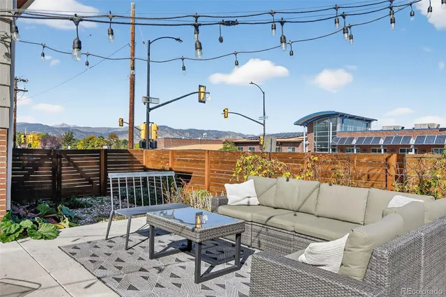 a roof deck with a table and chairs