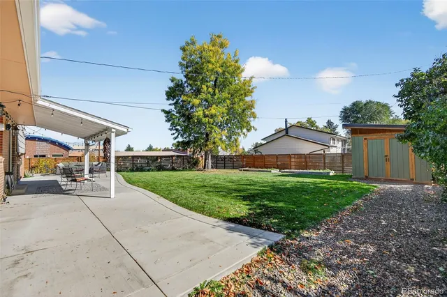 a front view of a house with a yard and potted plants