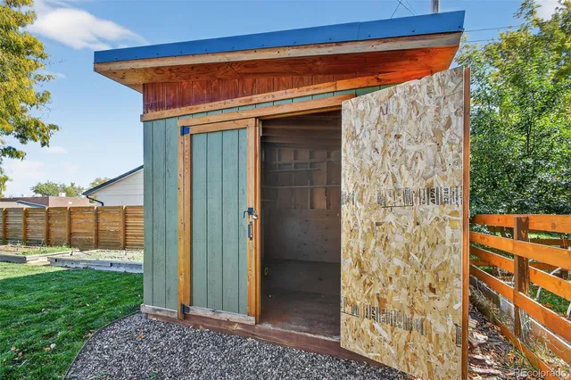 a view of a wooden door and a yard