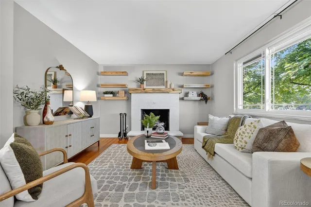 a living room with furniture and a fireplace