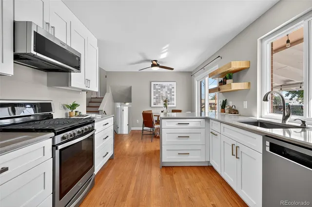 a kitchen with stainless steel appliances a stove sink and cabinets