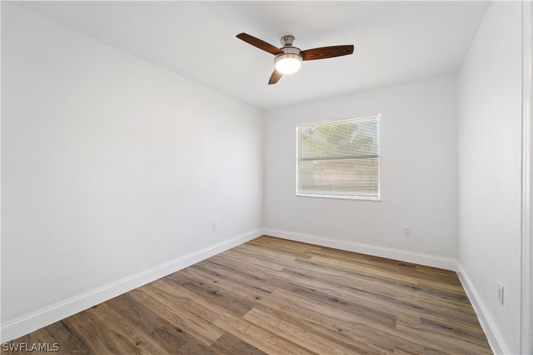 2345 Floyd Street Sarasota, FL 34239 - Photo 12 of 30 an empty room with wooden floor and windows