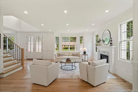 a living room with fireplace furniture and a wooden floor