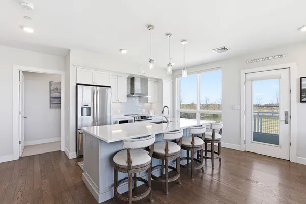 a large kitchen with a table and chairs