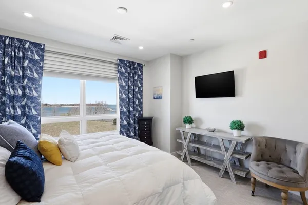 a bedroom with a bed and a flat screen tv