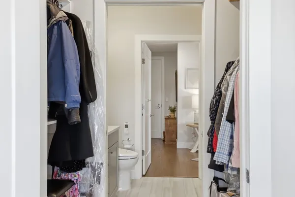 a view of walk in closet with clothes and shoes