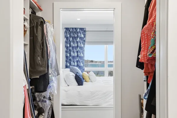 a view of walk in closet with clothes and shoes