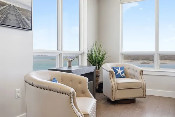 a living room with furniture and a potted plant