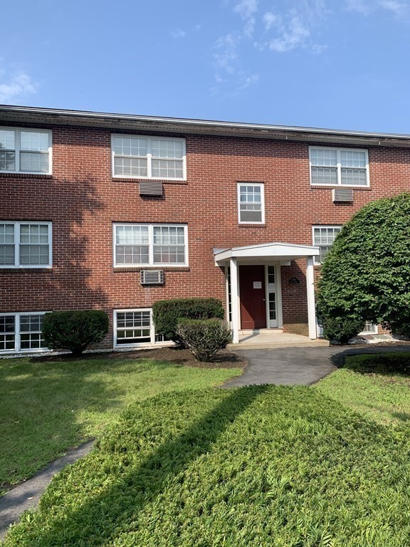 300 Main Street, Unit 3 Woburn, MA 01801 - Photo 1 of 9 a front view of a house with a yard