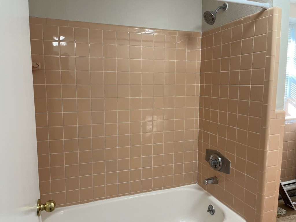 300 Main Street, Unit 3 Woburn, MA 01801 - Photo 9 of 9 a bathroom with a bathtub