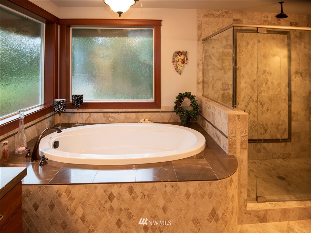 9415 Tveit Road Arlington, WA 98223 - Photo 22 of 28 a bathroom with a bathtub and shower