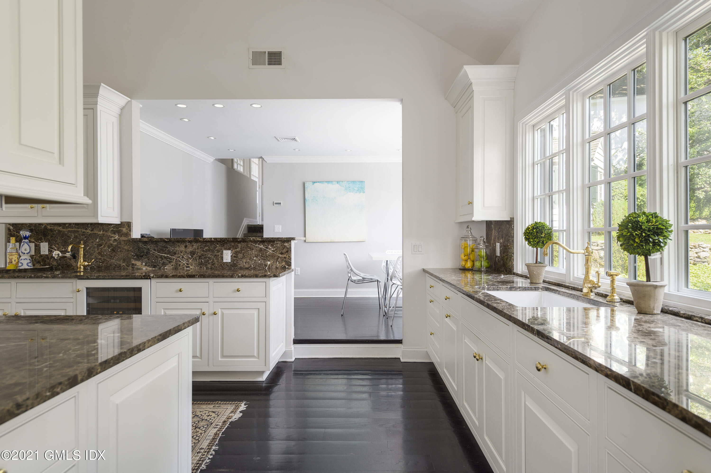 293 Riversville Road Greenwich, CT 06831 - Photo 14 of 38 a large white kitchen with stainless steel appliances granite countertop a lot of counter space and wooden cabinets