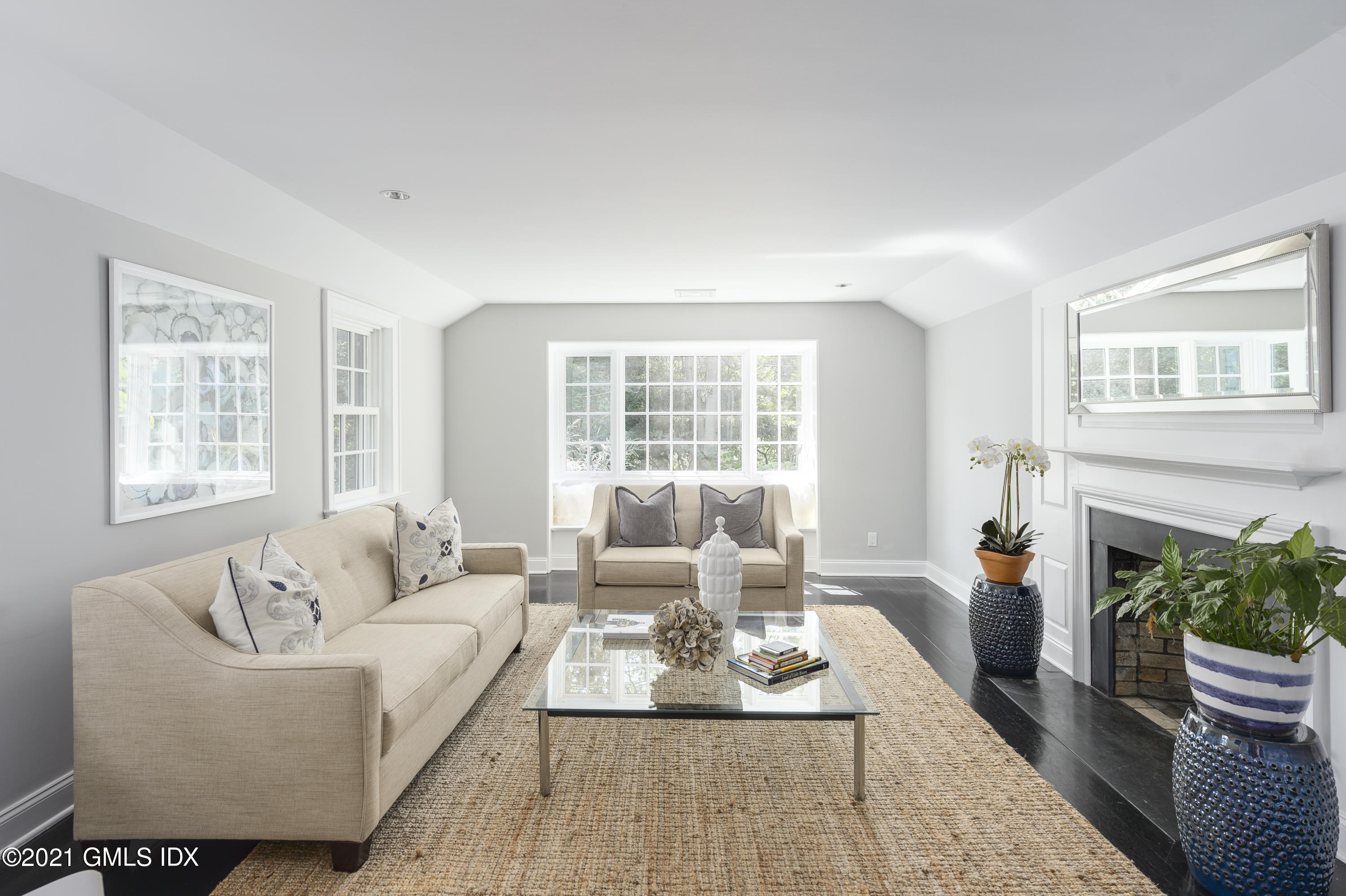 293 Riversville Road Greenwich, CT 06831 - Photo 27 of 38 a living room with furniture a fireplace and a large window