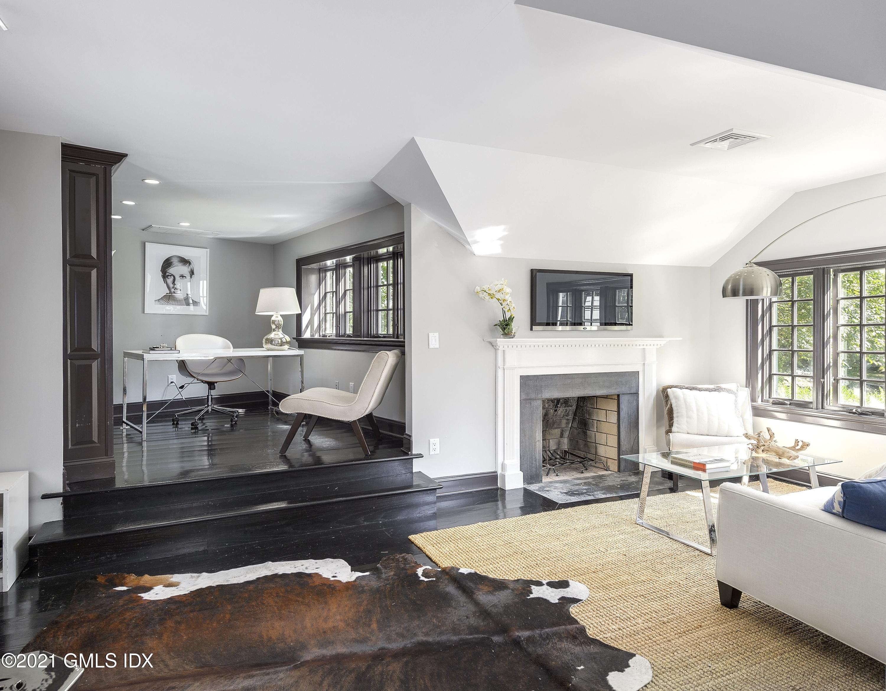 293 Riversville Road Greenwich, CT 06831 - Photo 8 of 38 a living room with furniture a fireplace and a table