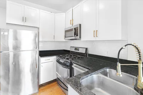 a kitchen with a sink stove and refrigerator