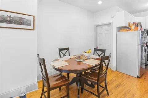 a view of a dining room with furniture and wooden floor