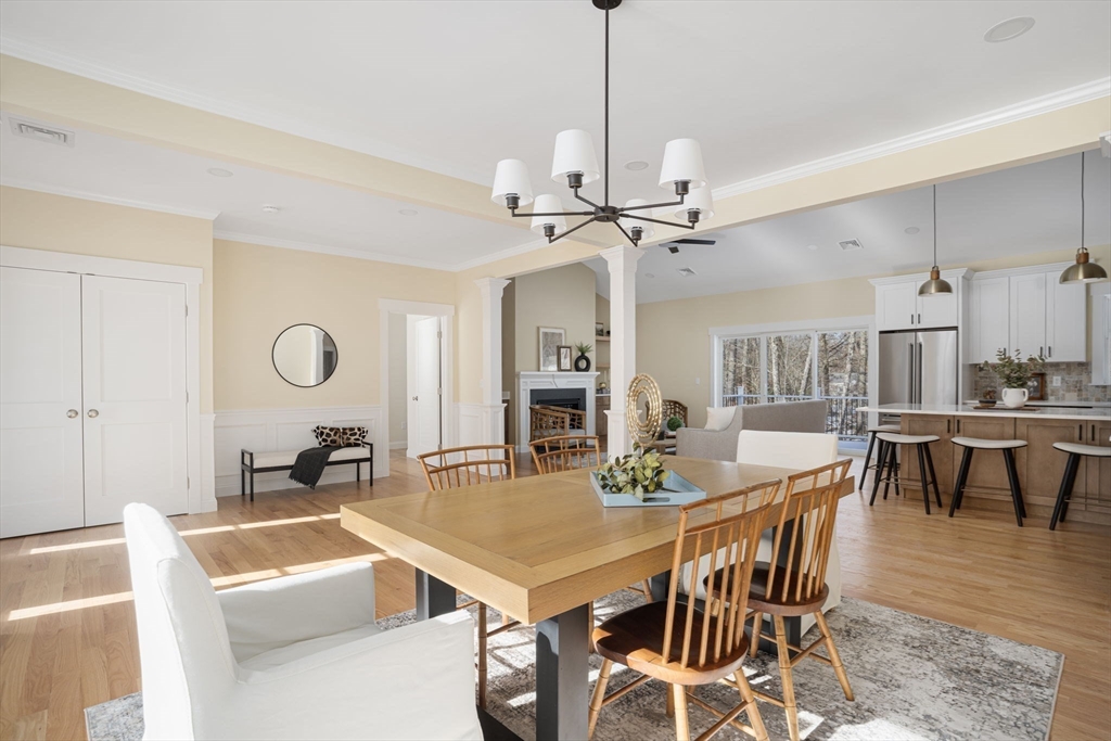660 Pine Street Seekonk, MA 02771 - Photo 16 of 37 a view of a dining room and livingroom with furniture wooden floor a chandelier