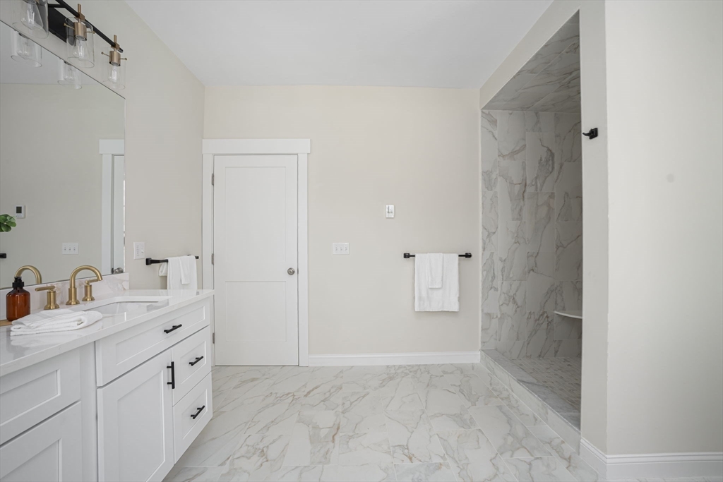 660 Pine Street Seekonk, MA 02771 - Photo 24 of 37 a spacious bathroom with a double vanity sink a mirror and a shower