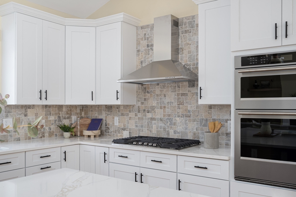 660 Pine Street Seekonk, MA 02771 - Photo 5 of 37 a kitchen with granite countertop a stove sink and cabinets