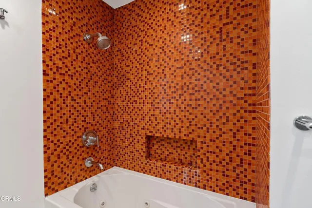 a bathroom with a bathtub and shower