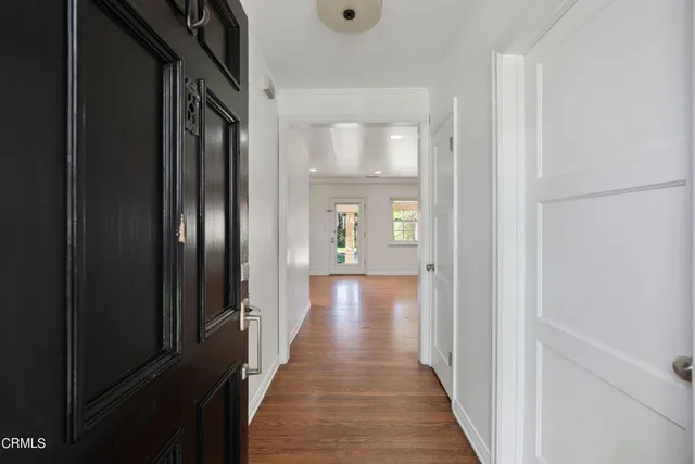 a view of a hallway with wooden floor