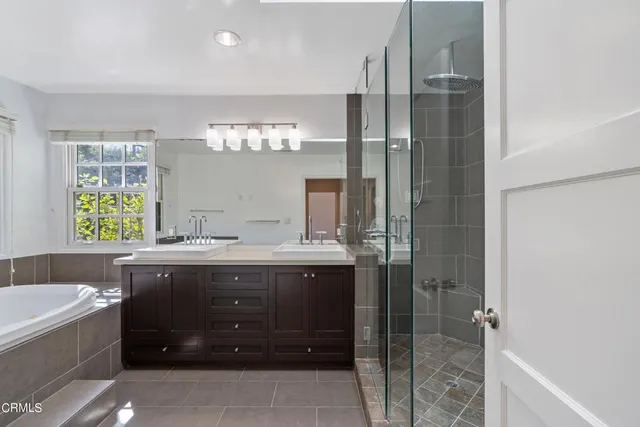 a bathroom with a bathtub sink and mirror