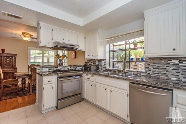 5833 Cochran Street Simi Valley, CA 93063 - Photo 2 of 28 a kitchen with a sink stove and cabinets