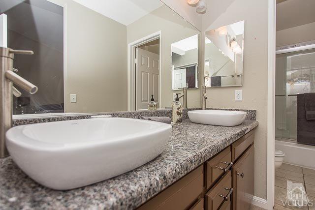 5833 Cochran Street Simi Valley, CA 93063 - Photo 14 of 28 a bath tub sitting next to a bathroom sink