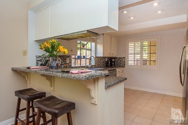 5833 Cochran Street Simi Valley, CA 93063 - Photo 3 of 28 a kitchen with a sink and cabinets