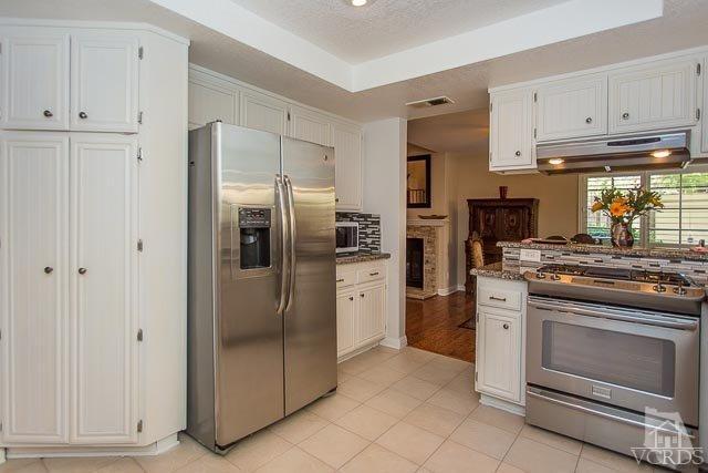 5833 Cochran Street Simi Valley, CA 93063 - Photo 6 of 28 a kitchen with stainless steel appliances granite countertop a refrigerator and a stove top oven