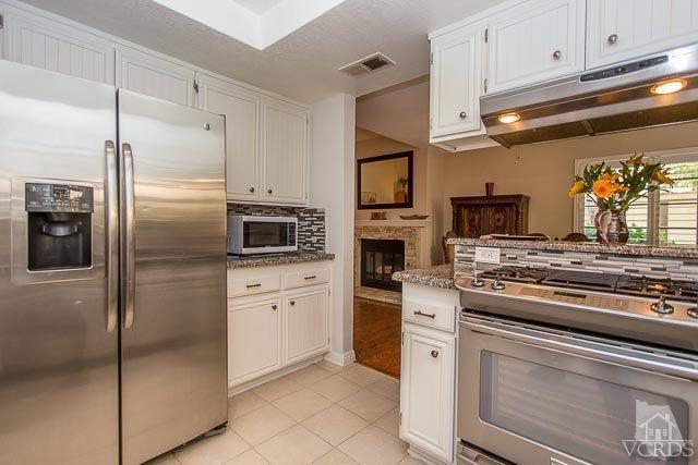 5833 Cochran Street Simi Valley, CA 93063 - Photo 8 of 28 a kitchen with stainless steel appliances granite countertop a refrigerator a stove and a sink