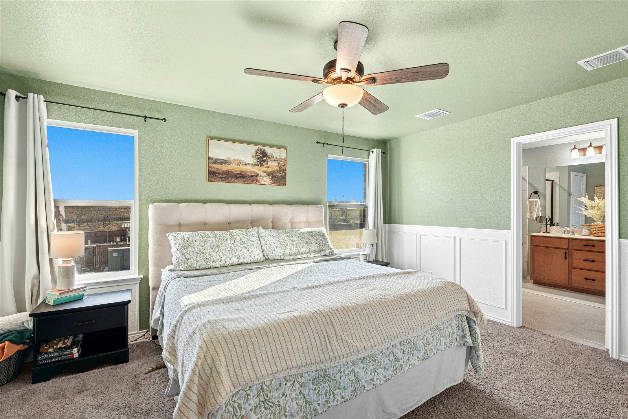 2001 Saskatoon Street Georgetown, TX 78626 - Photo 23 of 40 a bedroom with a large bed and a chandelier