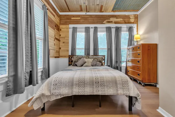 a bedroom with a bed and a large window