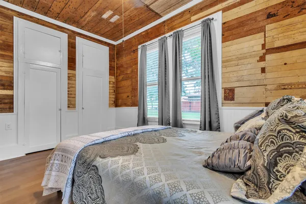 a kitchen with stainless steel appliances granite countertop a refrigerator a sink dishwasher a stove and a refrigerator with wooden floor