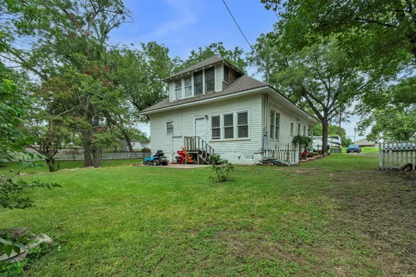 an aerial view of a house with yard