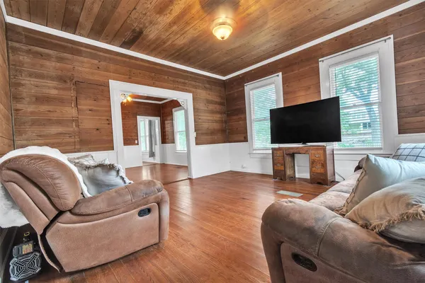 a spacious bedroom with a bed and large windows