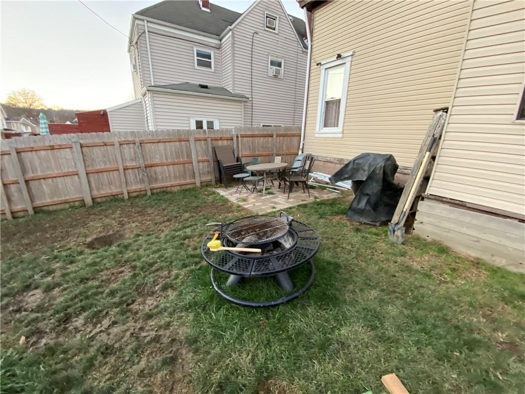 1038 Ridge Avenue Coraopolis, PA 15108 - Photo 17 of 17 a backyard of a house with fire pit and chairs