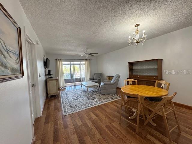 11485 Oakhurst Road, Unit 319 Largo, FL 33774 - Photo 8 of 63 a living room with furniture a flat screen tv and a table
