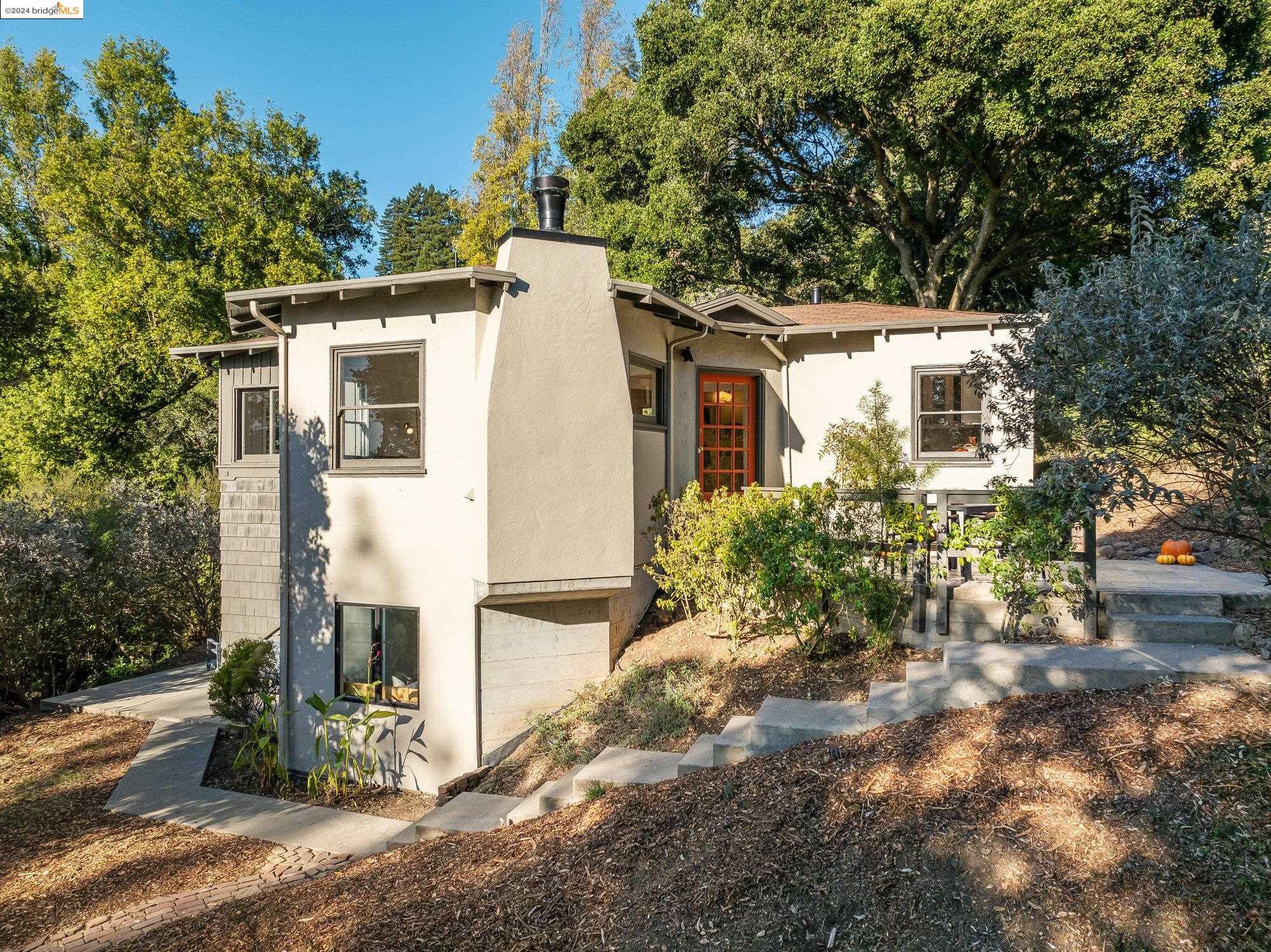 2785 Shasta Road Berkeley, CA 94708 - Photo 1 of 1 a view of a white house with large windows and a tree