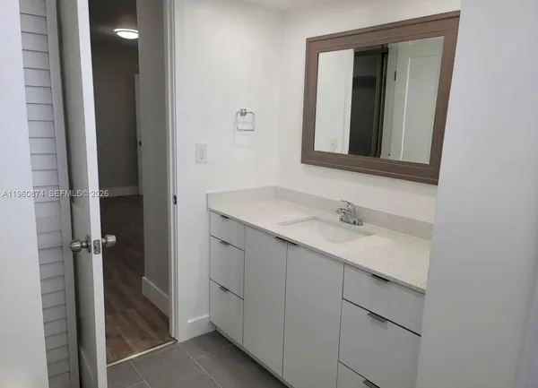a bathroom with a sink and mirror